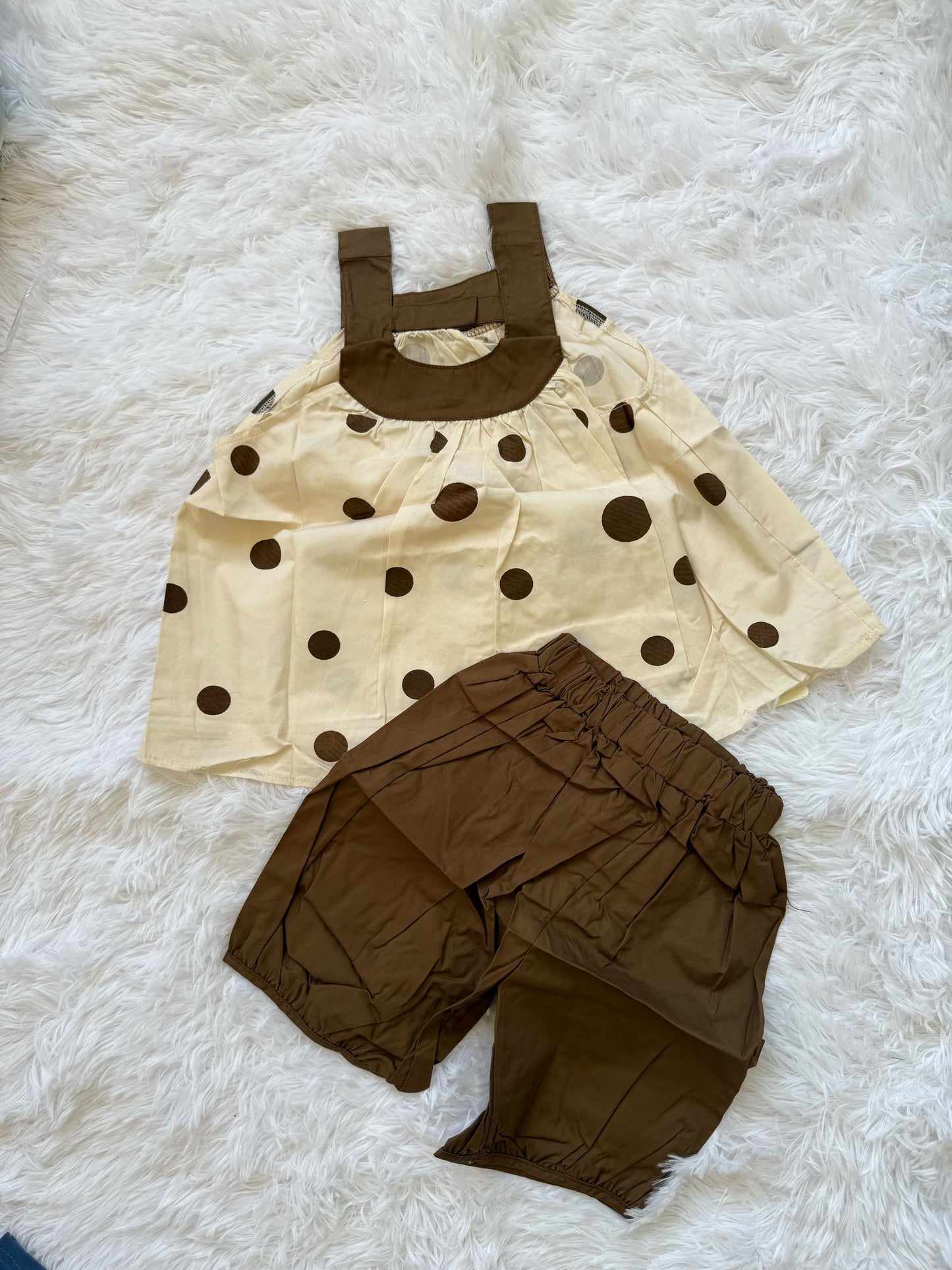 Brown colored sleevless top with dots with brown shorts
